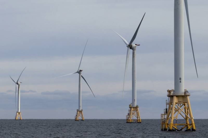 Wind turbines seen in the ocean.