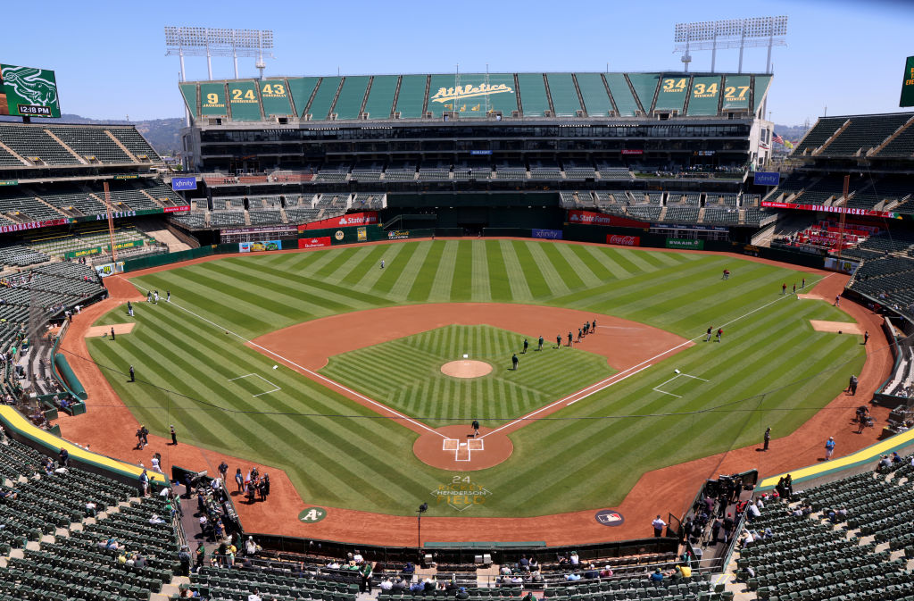 A wide shot of a baseball field with very green grass and a blue sky.