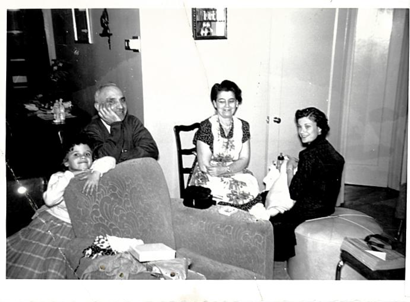 An old black-and-white photo of a family in their living room