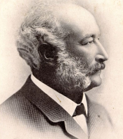 Black and white portrait of a white man with white hair and mutton chops whiskers.