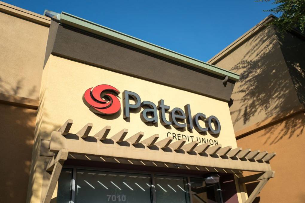 The facade of a building with a sign that reads "Patelco" with a swirling red logo to the left.