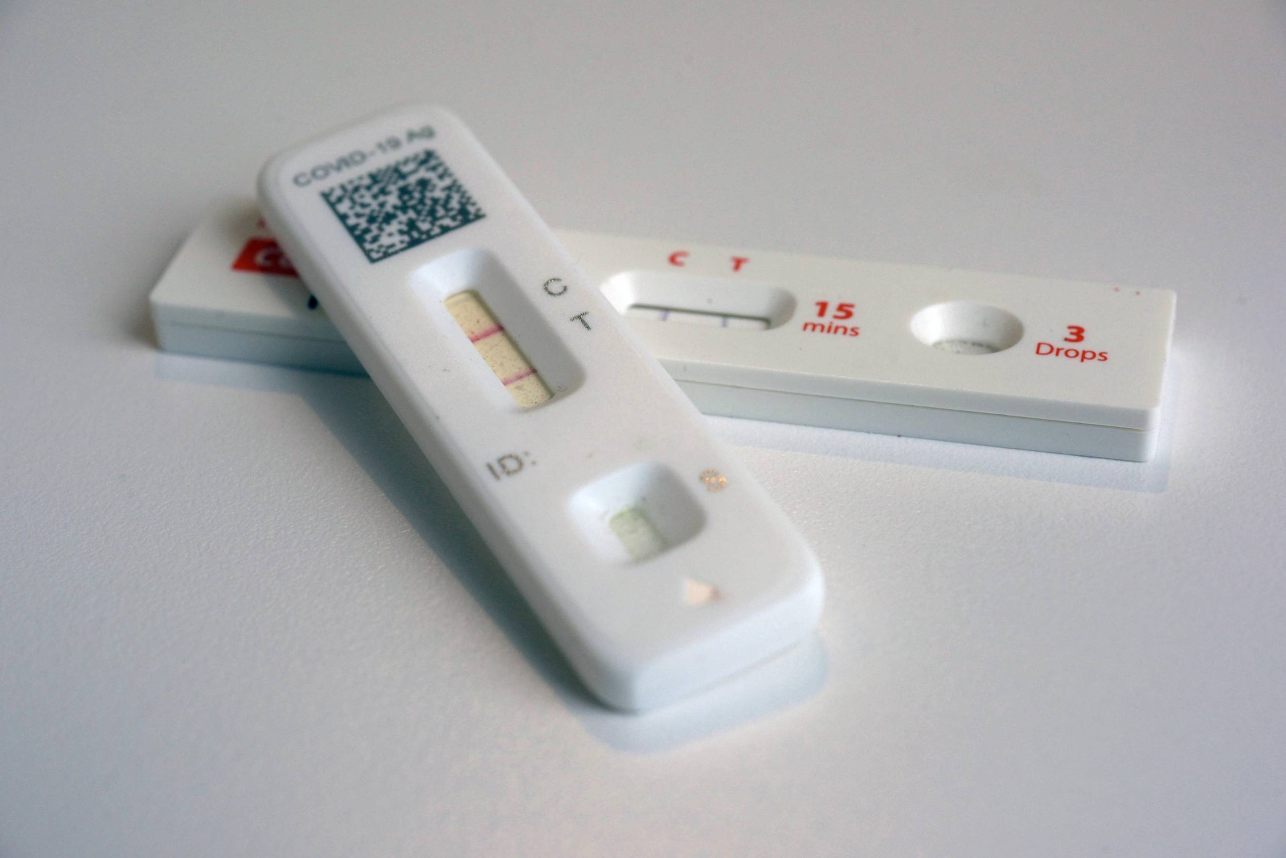 A closeup image of two COVID-19 antigen test results.
