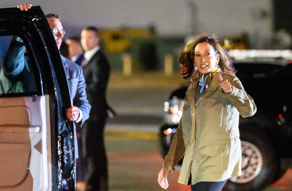 VP Harris gives a thumbs-up as she walks to a car.