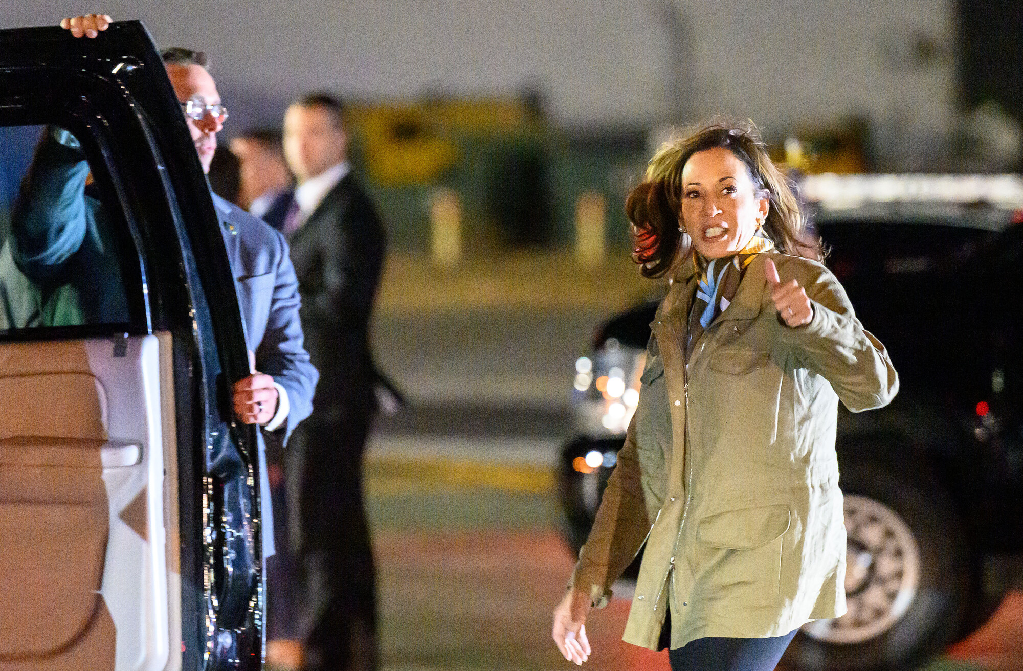 VP Harris gives a thumbs-up as she walks to a car.