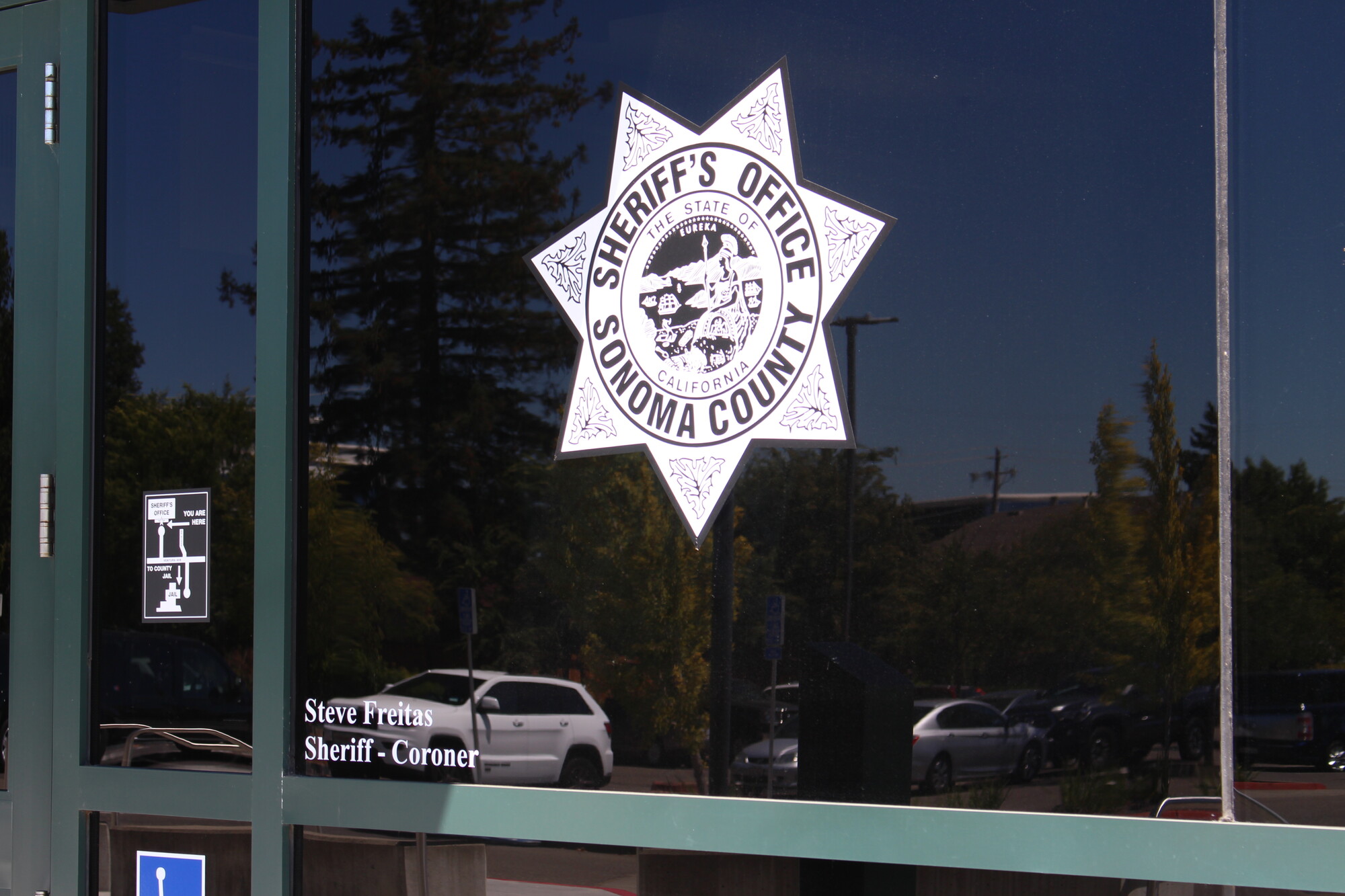 A glass window with a large badge symbol that says 'Sonoma County Sheriff's Office.'