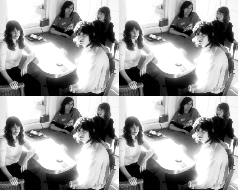A collage of four black and white images of two men and two women seated at a table.