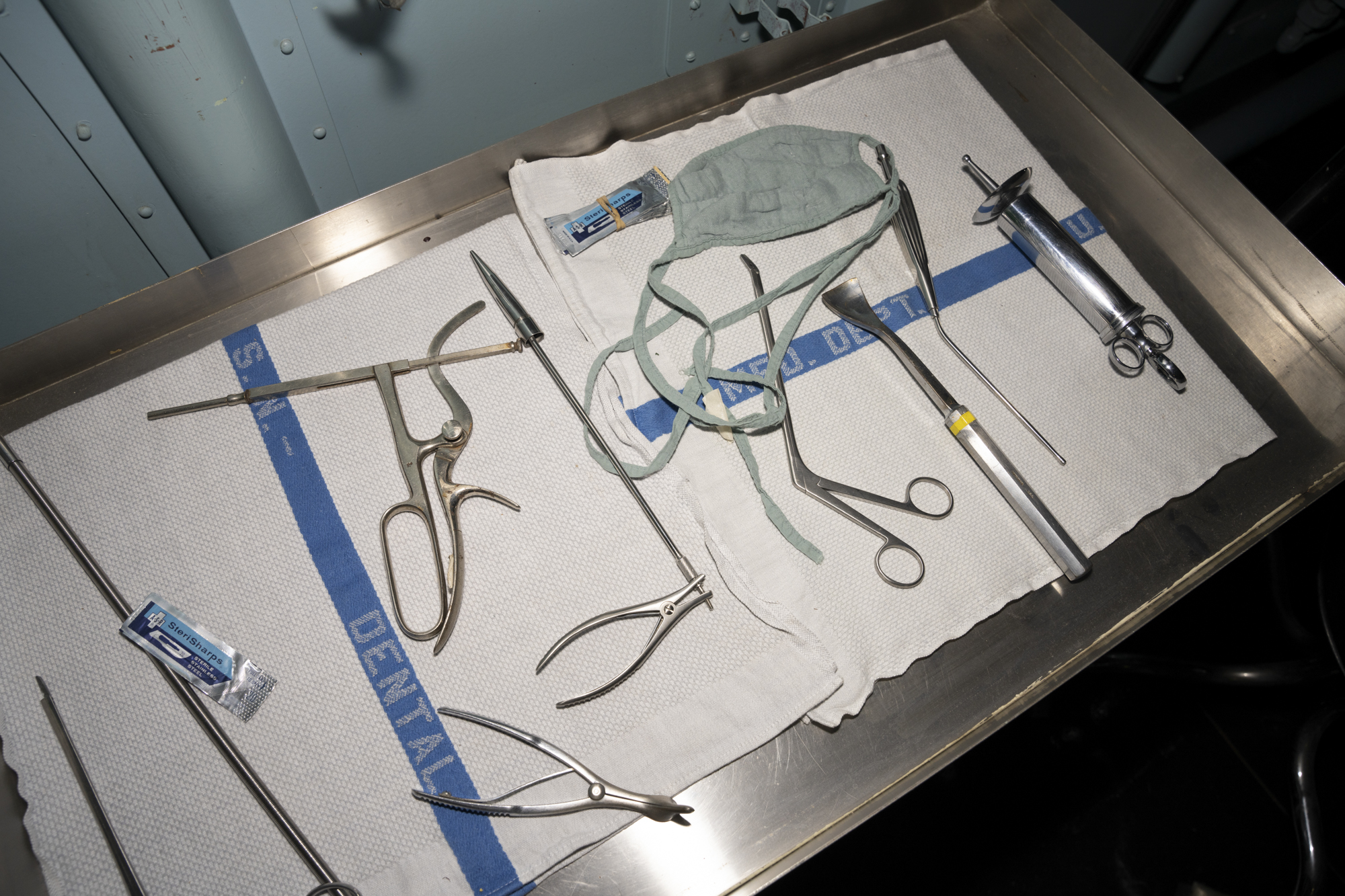 Old-fashioned operating tools on metal table.
