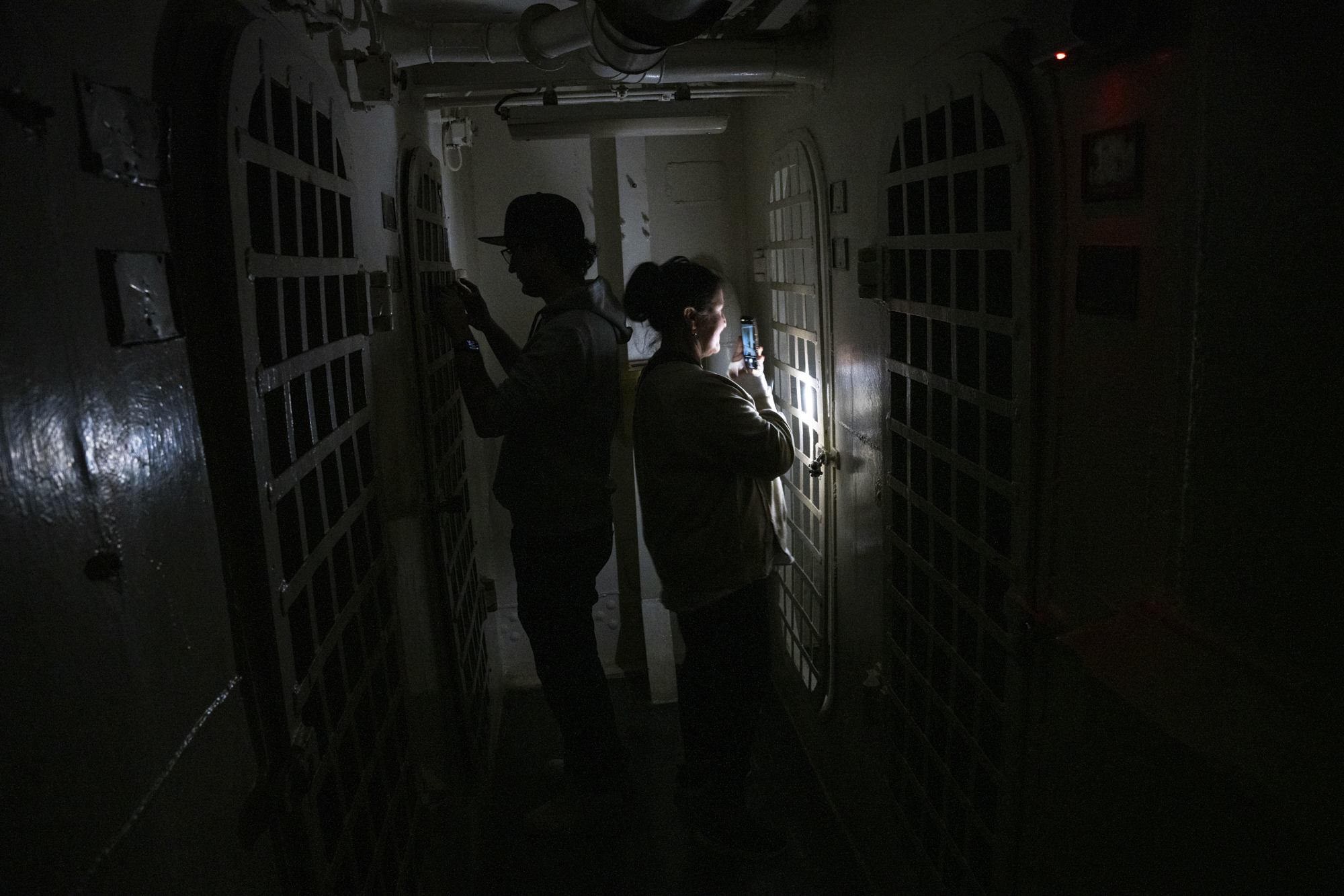 Several people stand in a dark, tight enclosure.