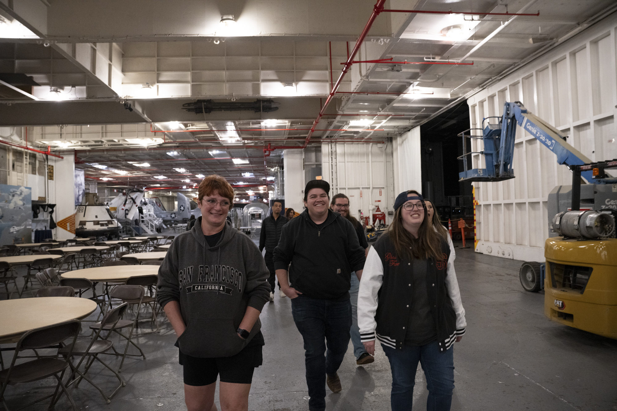 A group of people walk around on a ship.