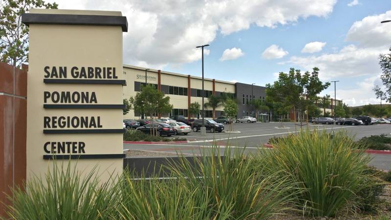A large, 2-story office building with a sign that says: 'San Gabriel-Pomona Regional Center.'