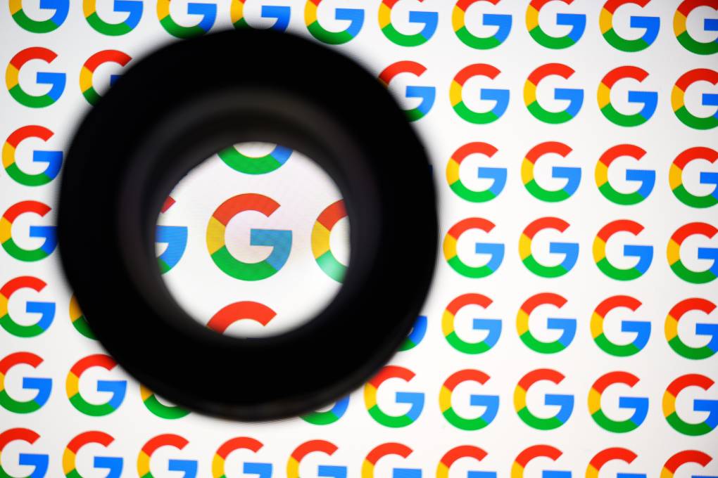 An illustration of the multicolored Google logos with a magnifying glass over one 'G' in particular.