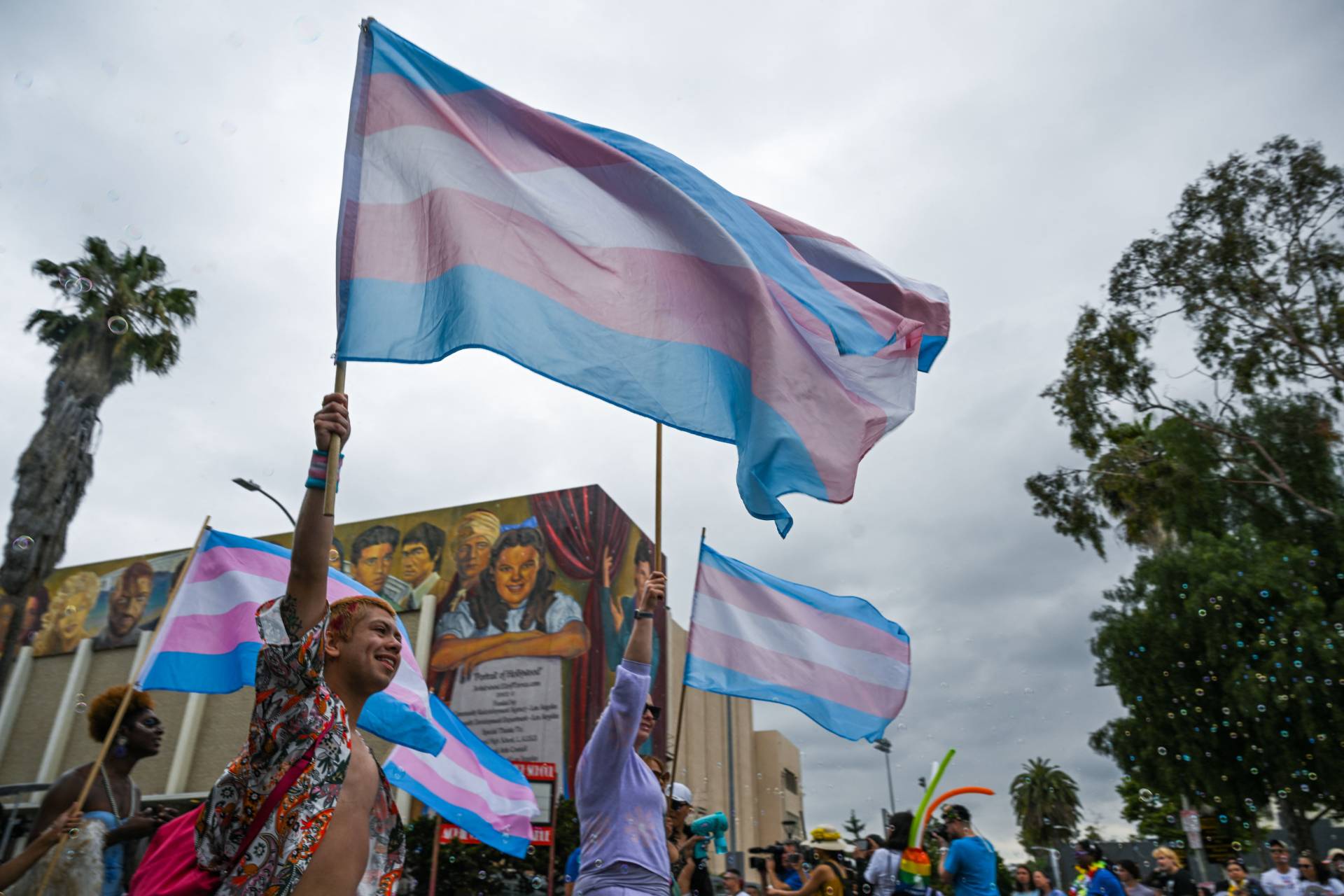 A demonstrator waves a Transgender Pride flag in 2023 in Los Angeles. As Donald Trump prepares to re-enter the White House, advocates for trans communities have expressed deep concerns about trans rights over the coming years. ROBYN BECK/AFP via Getty Images