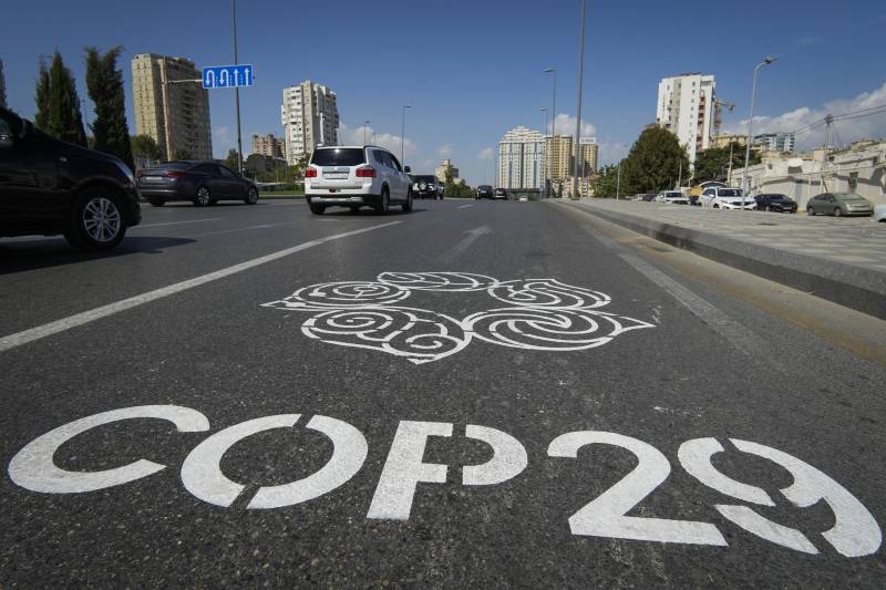 A street with the letters COP29 and a logo.