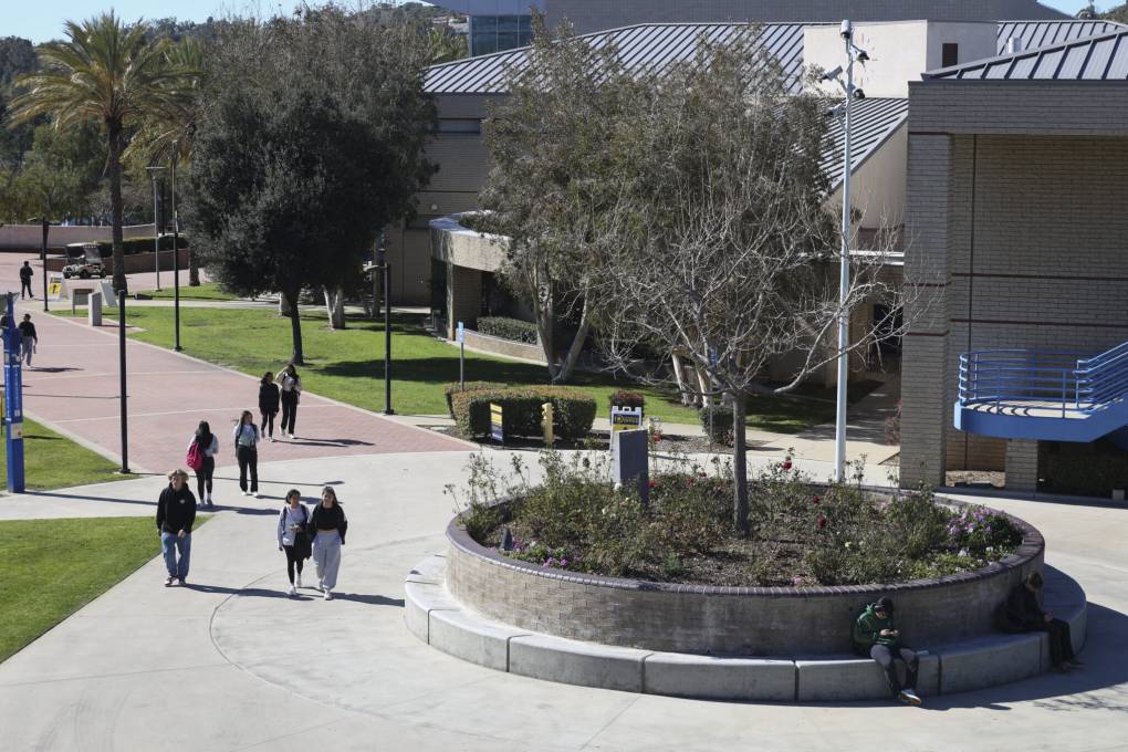 An aerial view of a college campus with people walking around.