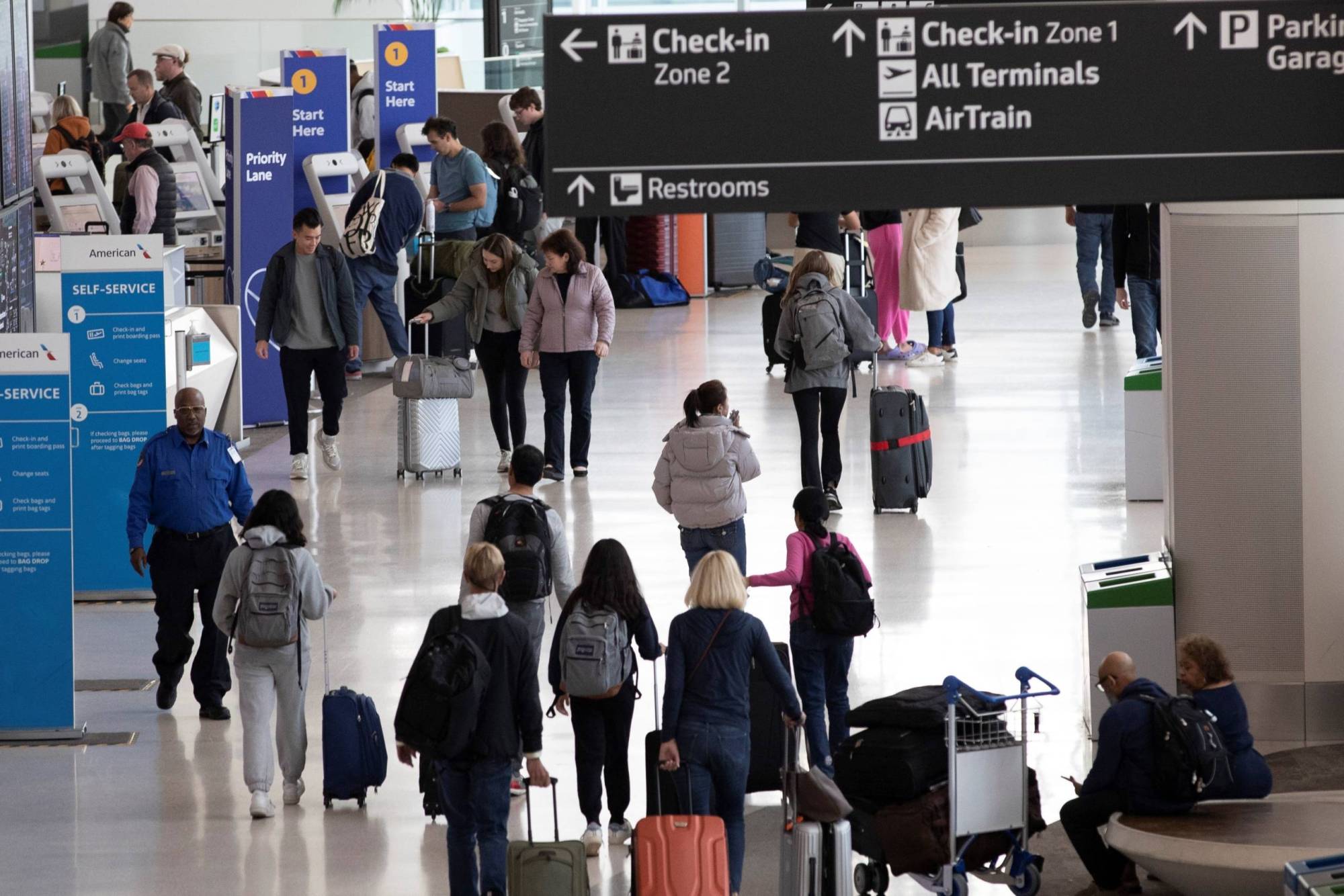 A crowded hallway at a busy airport.
