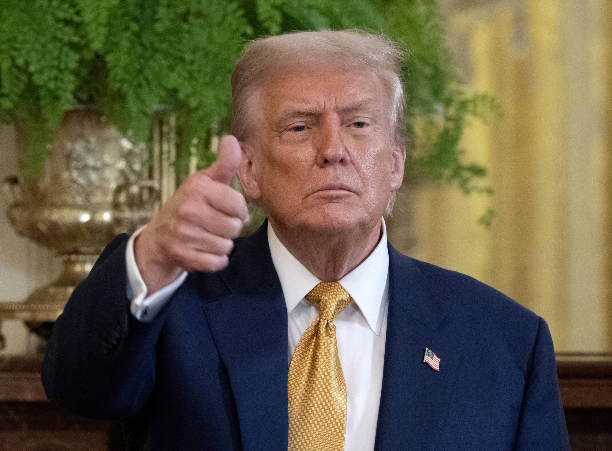 President Trump gestures to the press at the end of a reception with Republican members of Congress at the White House on July 22, 2025.