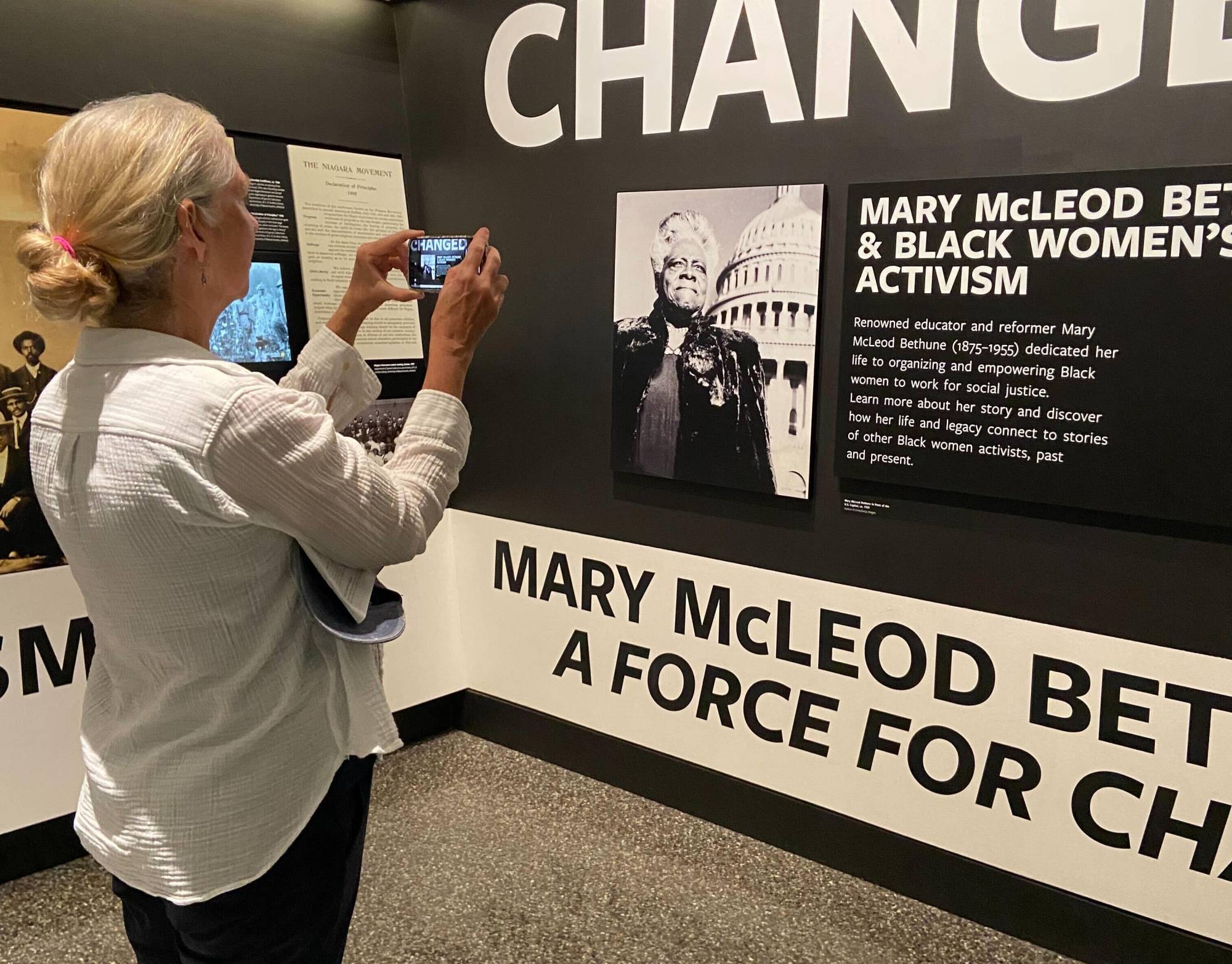 Shelley Smith, a retired public health professional, is one of hundreds of volunteers documenting wall text, objects and images at the Smithsonian as part of an effort to document what's there now before any changes are made as a result of the Trump Administration's continued pressure on the institution.