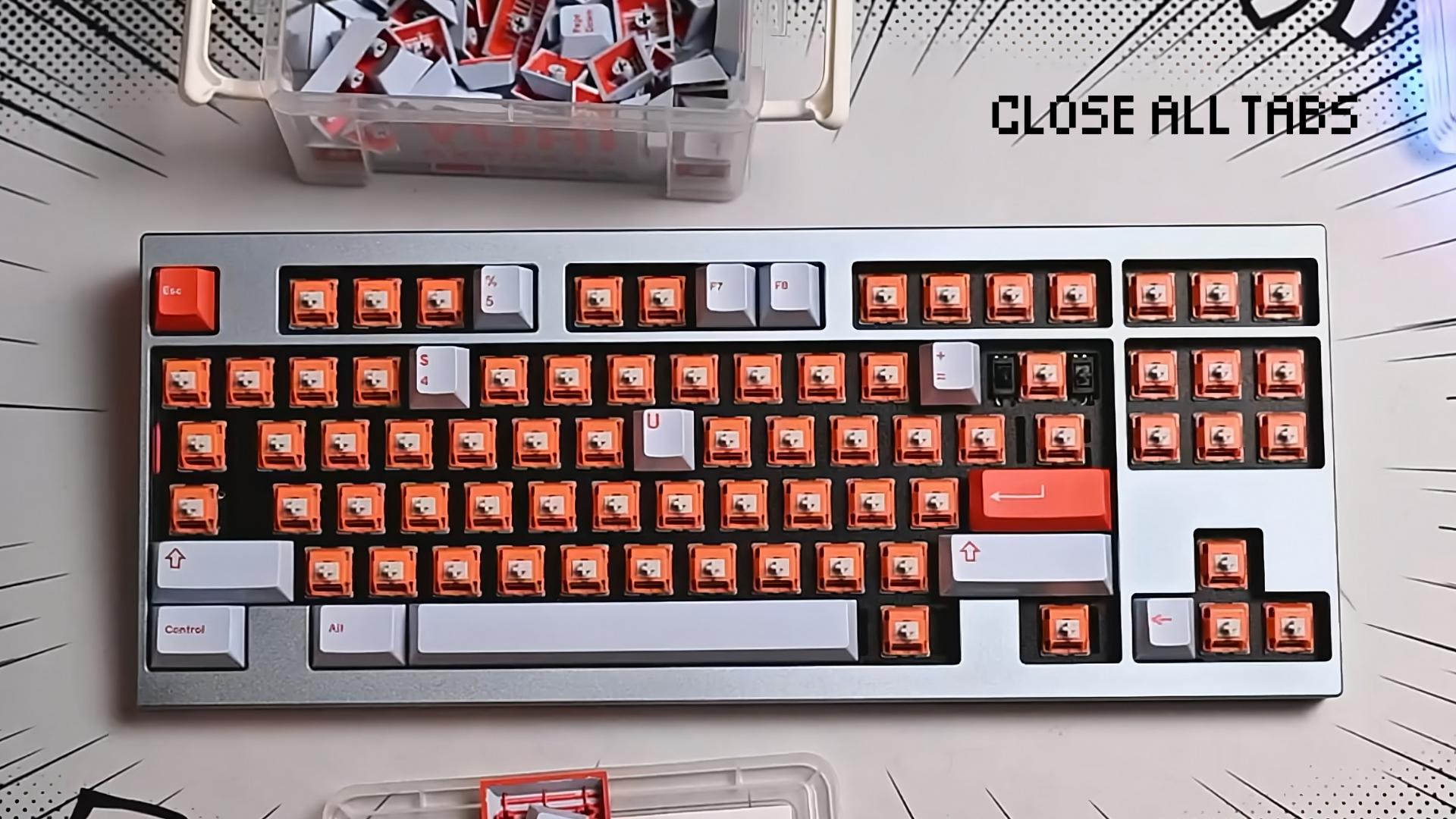 A close-up of a custom mechanical keyboard mid-assembly, placed on a comic-style desk mat with bold black lines radiating outward. The board has orange switches exposed, with a few red and white keycaps already installed. A plastic bin of loose keycaps sits above the keyboard, and the words “Close All Tabs” appear in pixel-style font in the upper right corner.