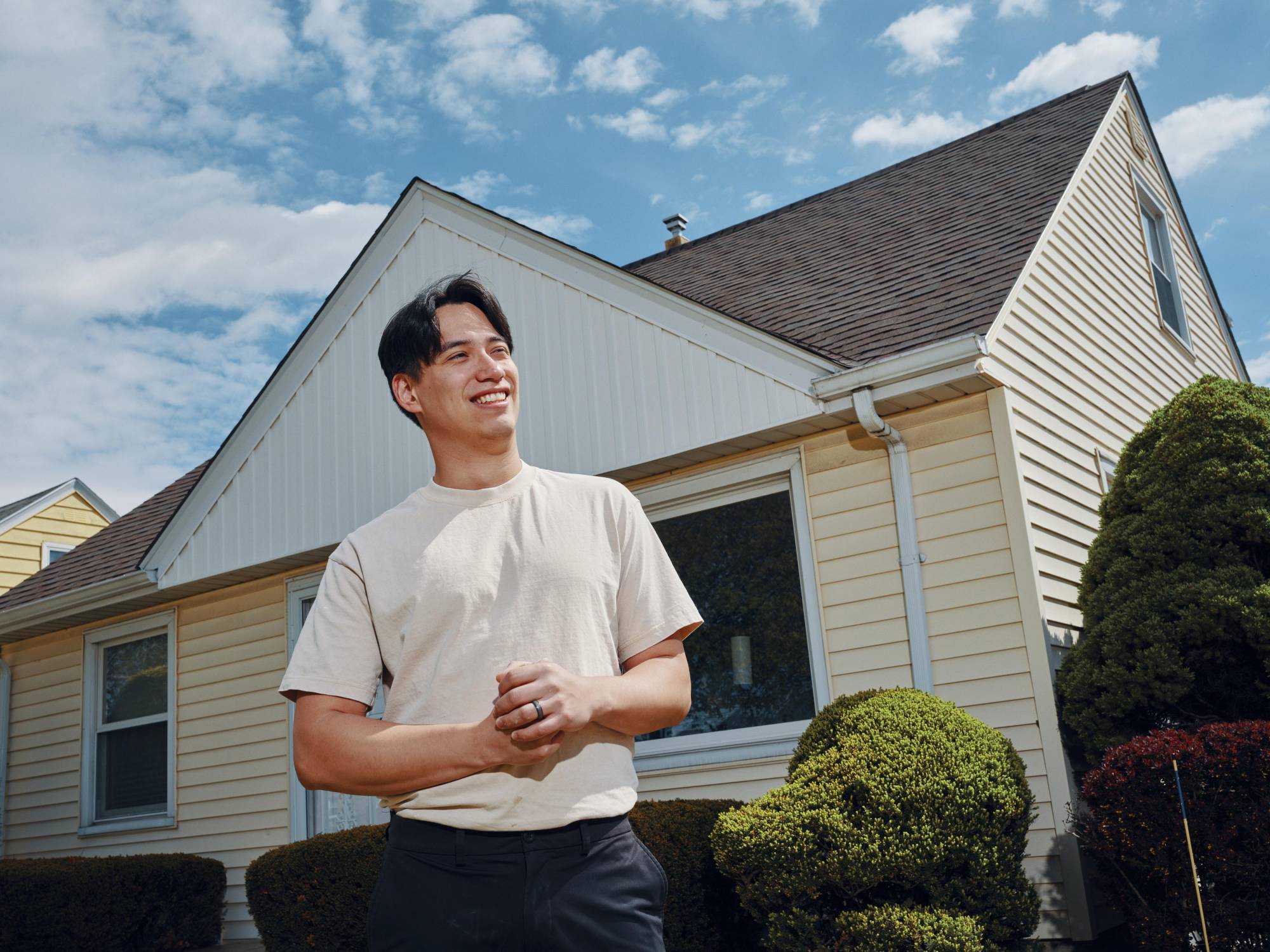 Francisco Vazquez, 27, stands in front of his new home in Milwaukee, Wis. He was able to buy it after changing his career track and saving aggressively, including for one year while he lived rent free with his parents.