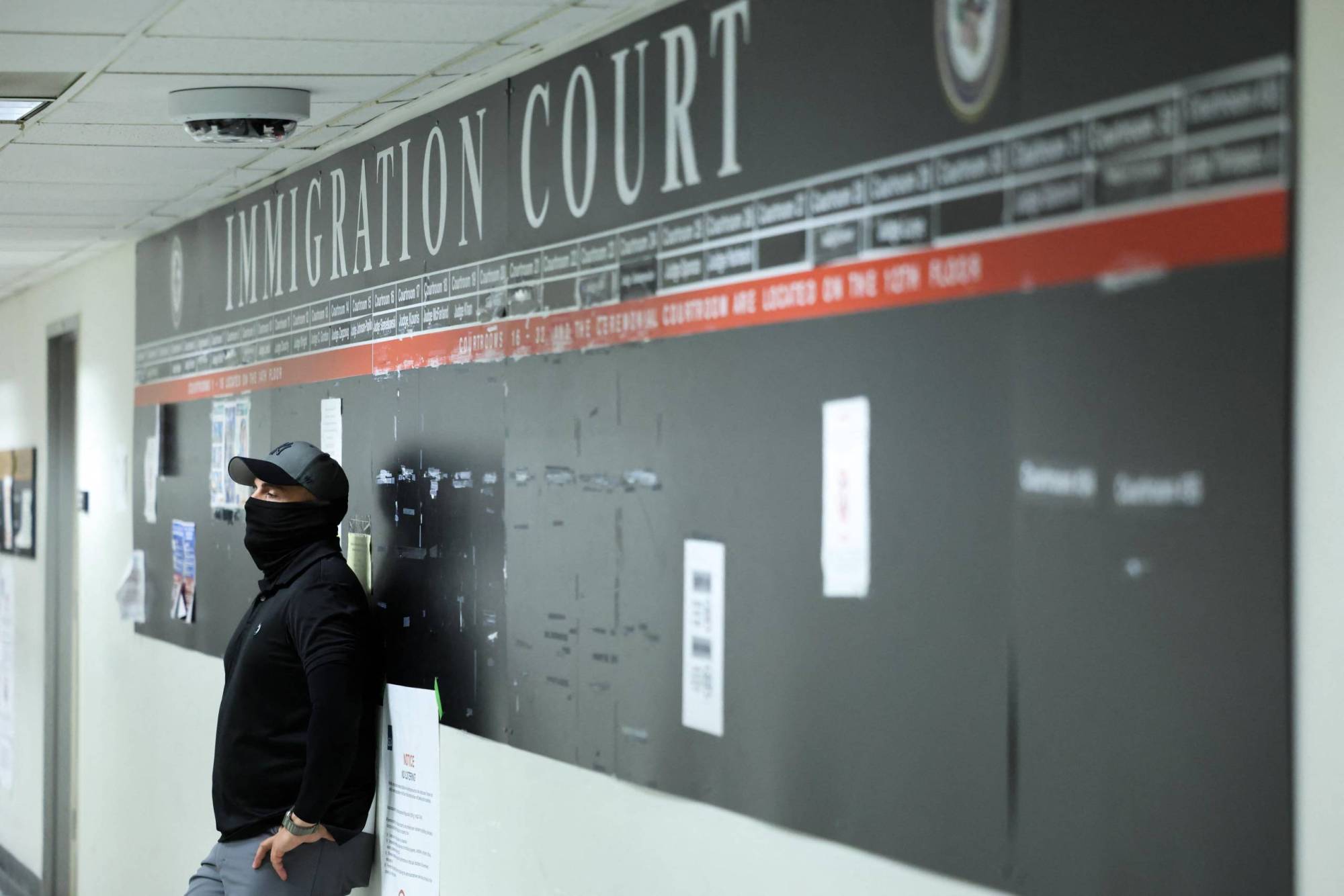 A federal officer stands in a hallway at New York Federal Plaza Immigration Court inside the Jacob K. Javitz Federal Building in New York in October 2025.