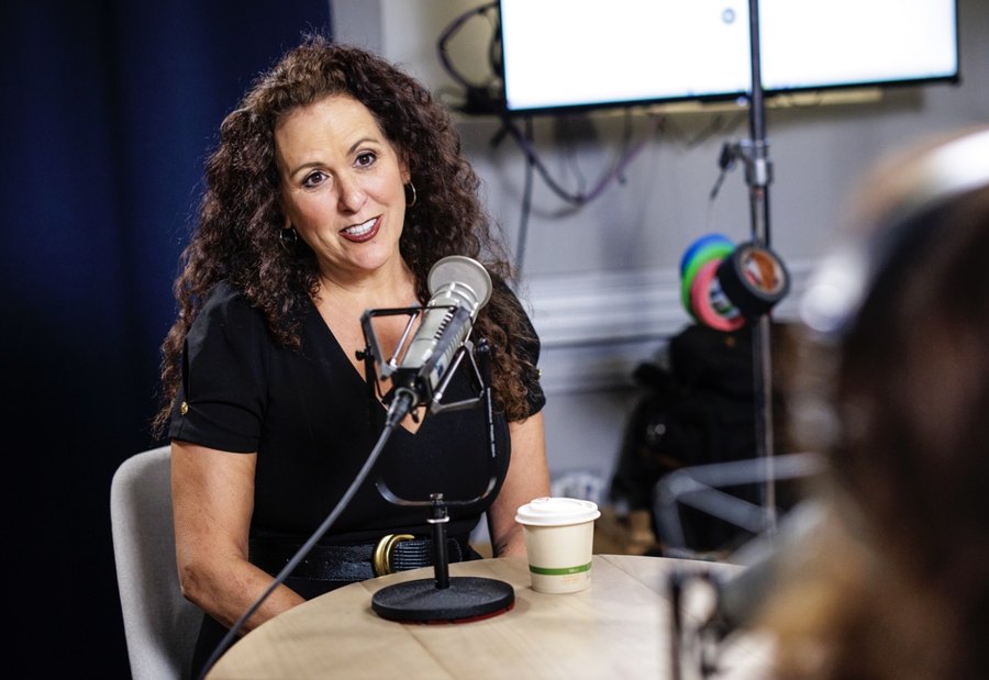 A labor leader speaking into a microphone in a radio studio.