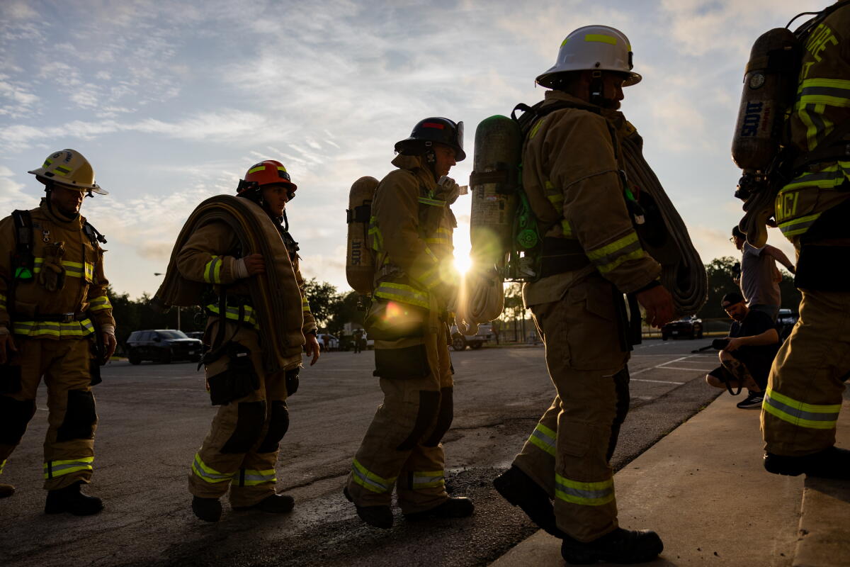 Austin firefighters enter the Pleasant Valley Tower during the annual Austin Fire Department Memorial Stair Climb on Friday.