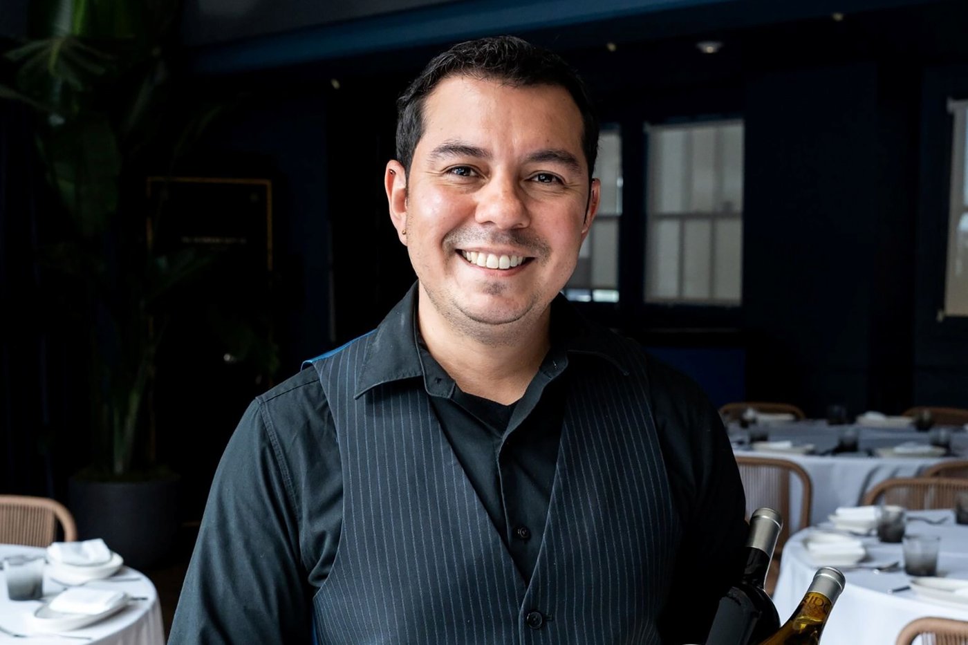 La Mar beverage director Uriel Serrano smiles in the restaurant's dining room.