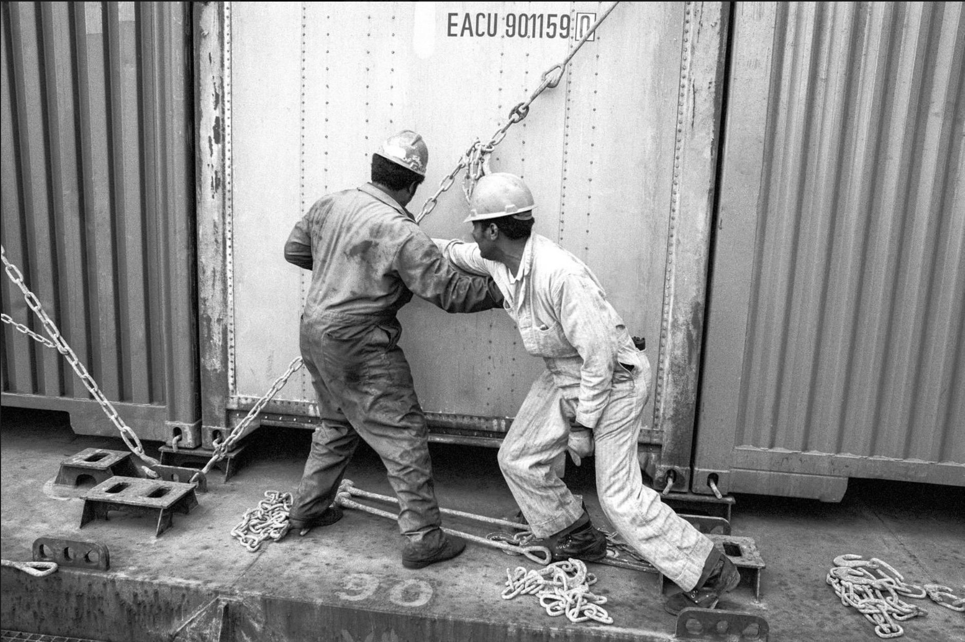 Two men work on the waterfront