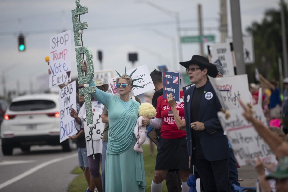 In Fort Myers, Fla., Diane Scire dressed as Lady Liberty held a sparkling flame and waved as vehicles honked. The 59-year-old construction company owner said she urged everyone to vote.