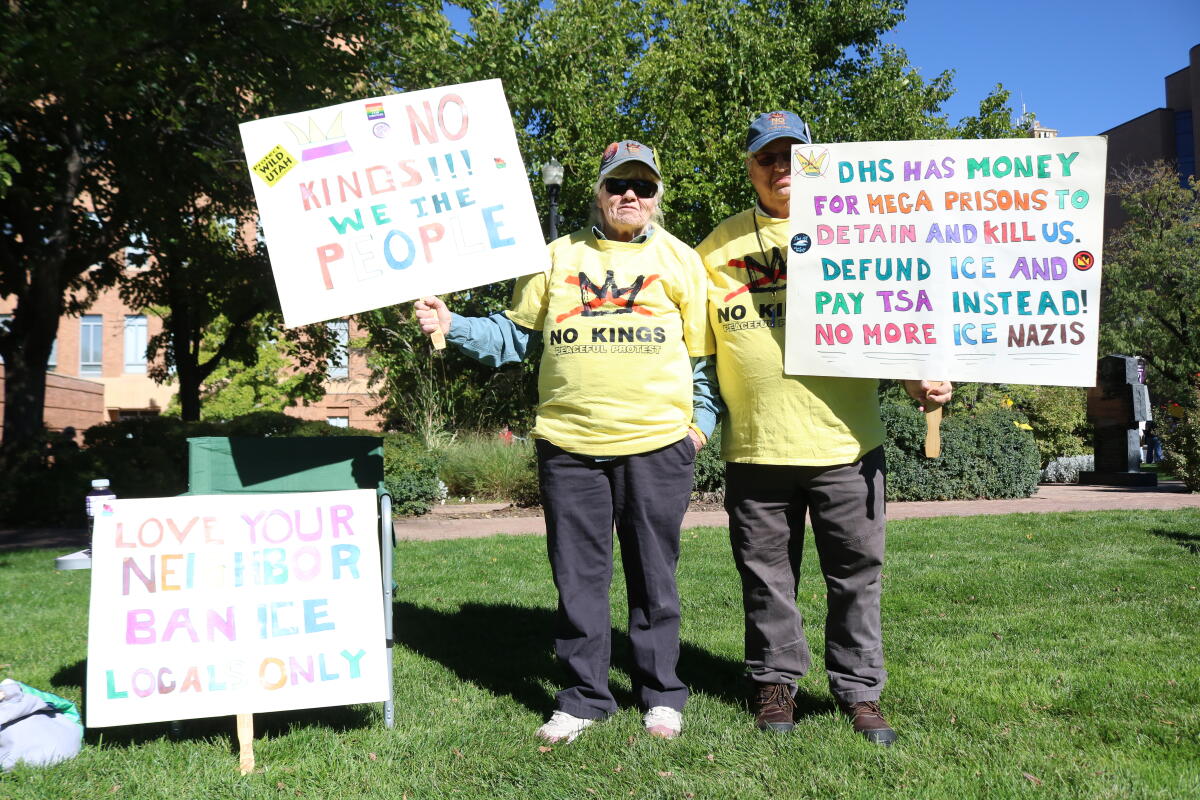 Cheryl Singleton and Sandy Hill of West Point, Utah, hold signs at the No Kings rally outside the Ogden Municipal Building in Ogden, Utah, on Oct. 17.