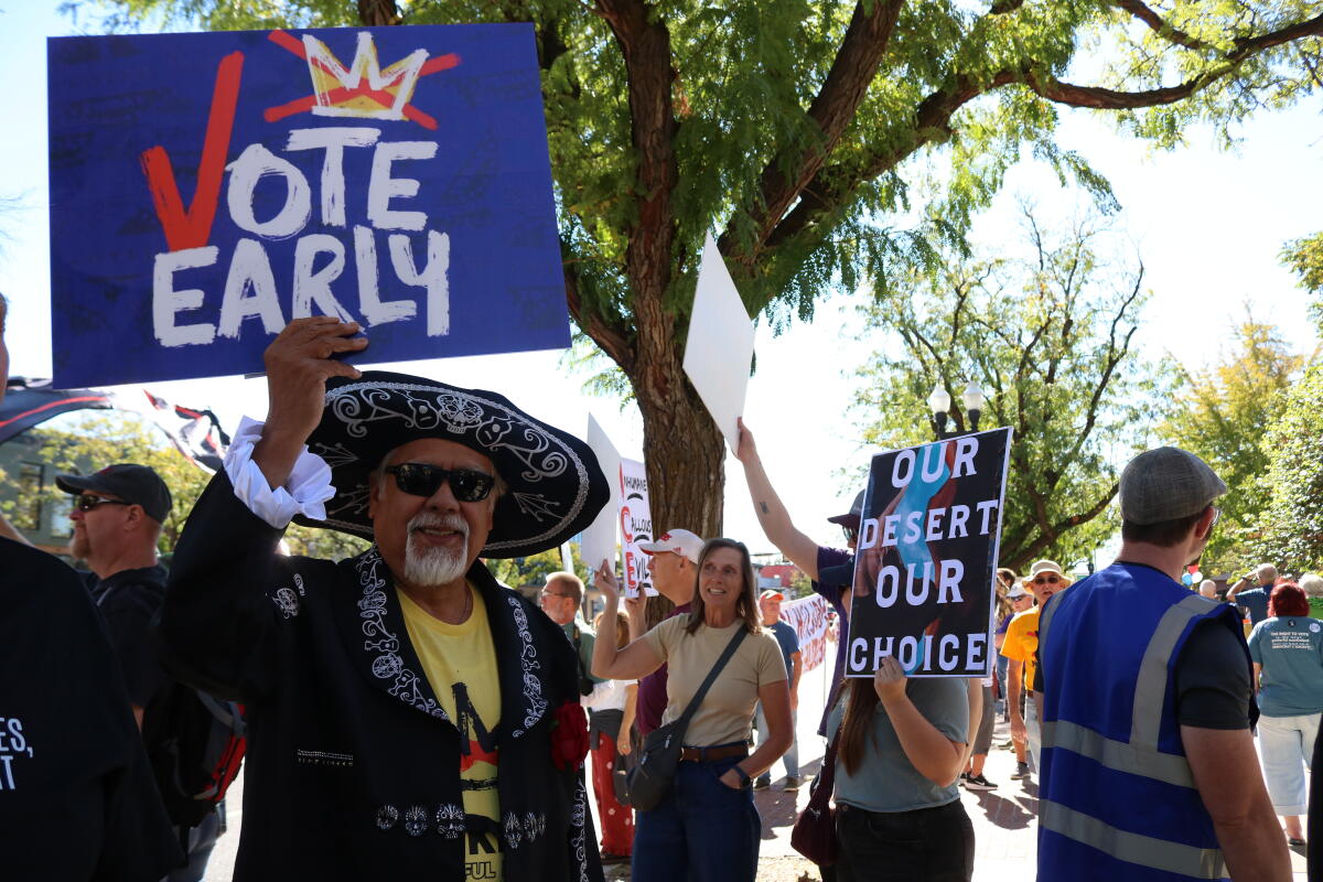 Paul Hinojosa holds a 'Vote Early' sign at a No Kings rally in Ogden, Utah, about 40 miles north of Salt Lake City, on Oct. 17.