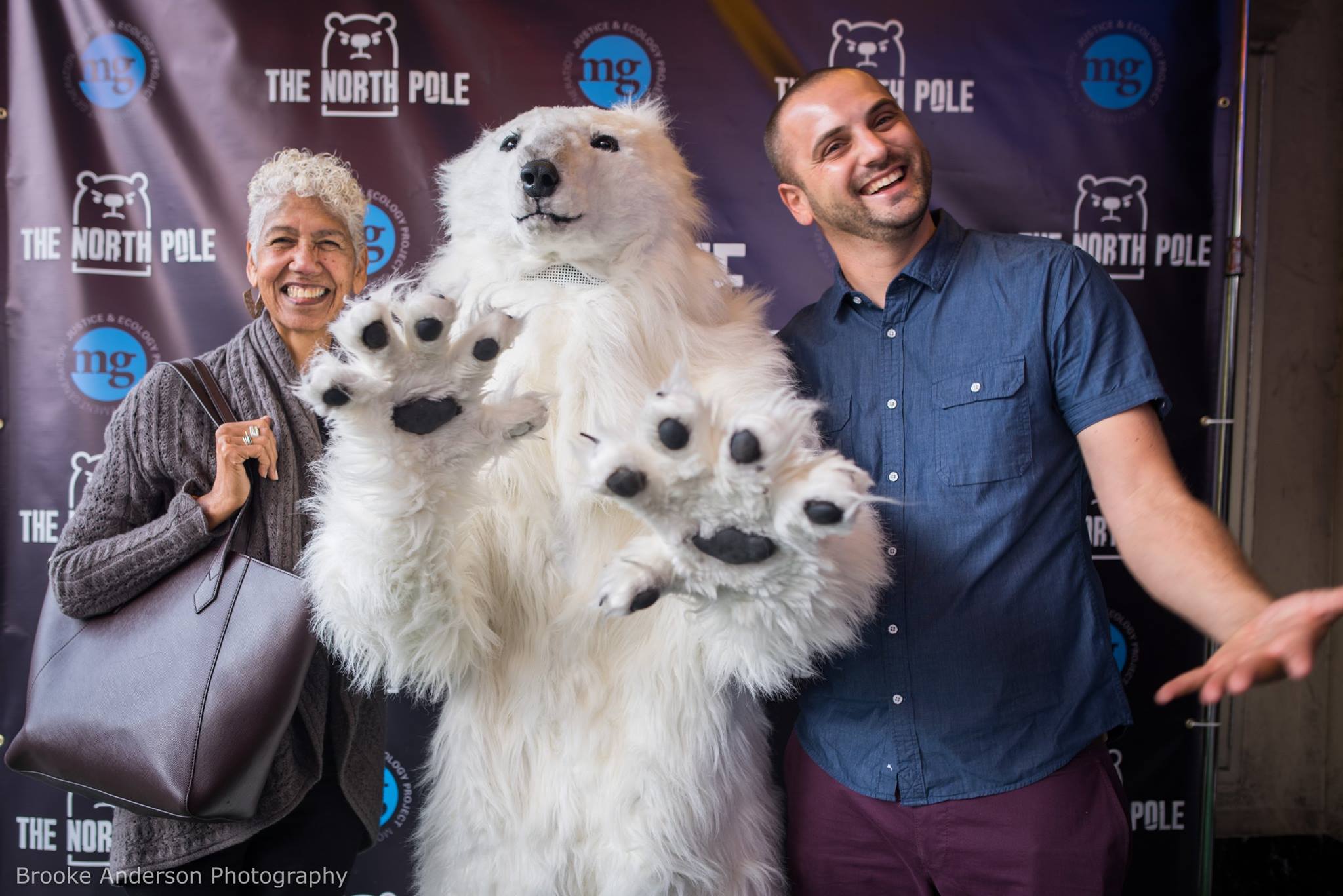 woman and man pose with polar bear