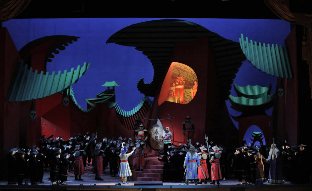 David Hockney's set design for Act I of SF Opera's "Turandot." In Hockney’s 1993 book "That’s the Way I See It," he wrote "I had seen many productions, most of them kitsch beyond belief, overdone chinoiserie and too many dragons… For the first scene, the city of Peking, I suggested that we take the dragons away and put them into the roofs, in forms that felt like dragons, without specifically looking like them, thus evoking the grotesqueness of the city."