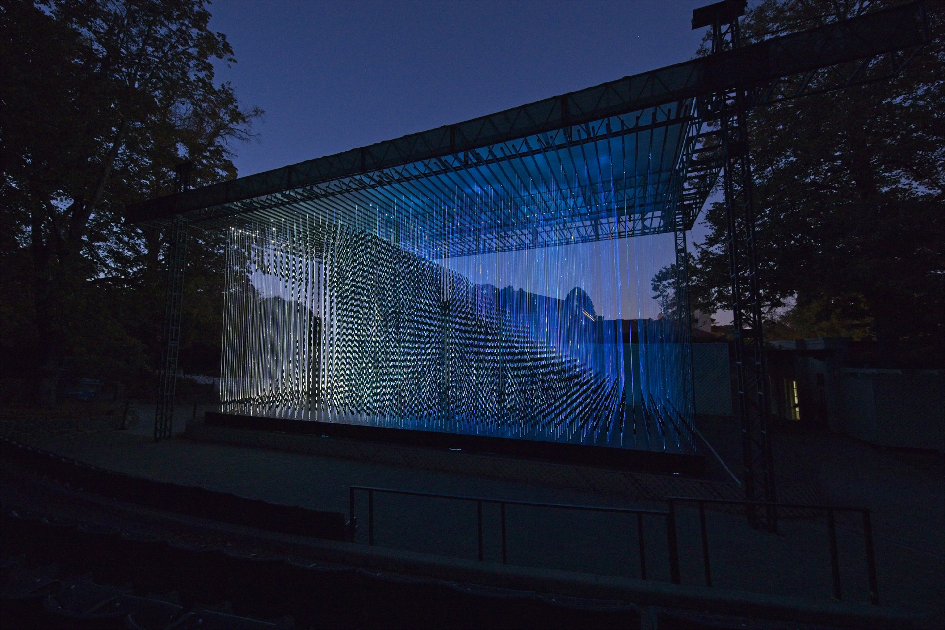 "Stories in Light" includes "Reepicheep's Wave," on display in the Garden Theatre at Montalvo Arts Center. This piece features over 15,000 plastic mussel shells suspended on illuminated optical fibers.
