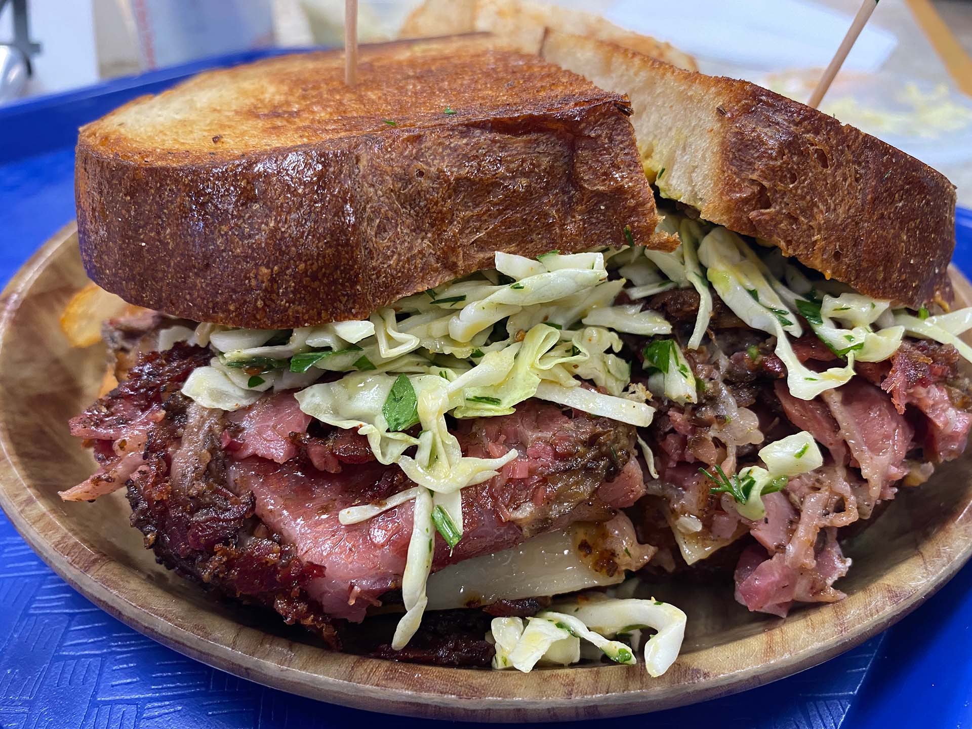 A massive sandwich overflowing with pastrami and slaw.