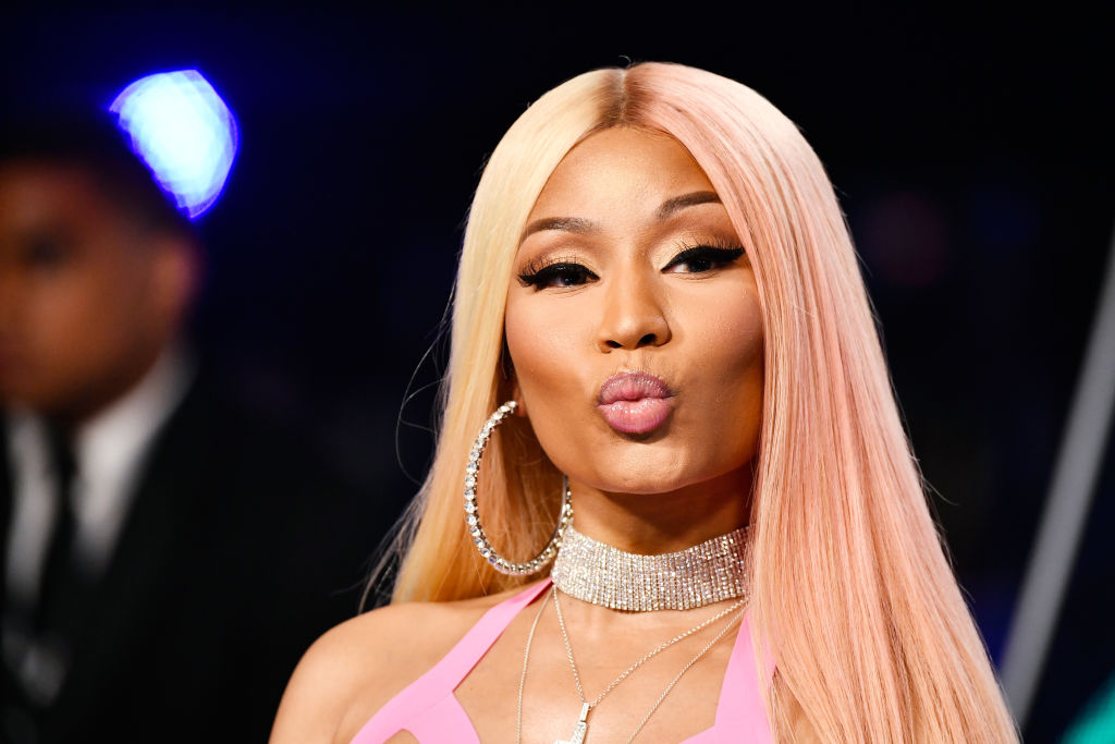 Nicki Minaj pouts at the camera on a red carpet.