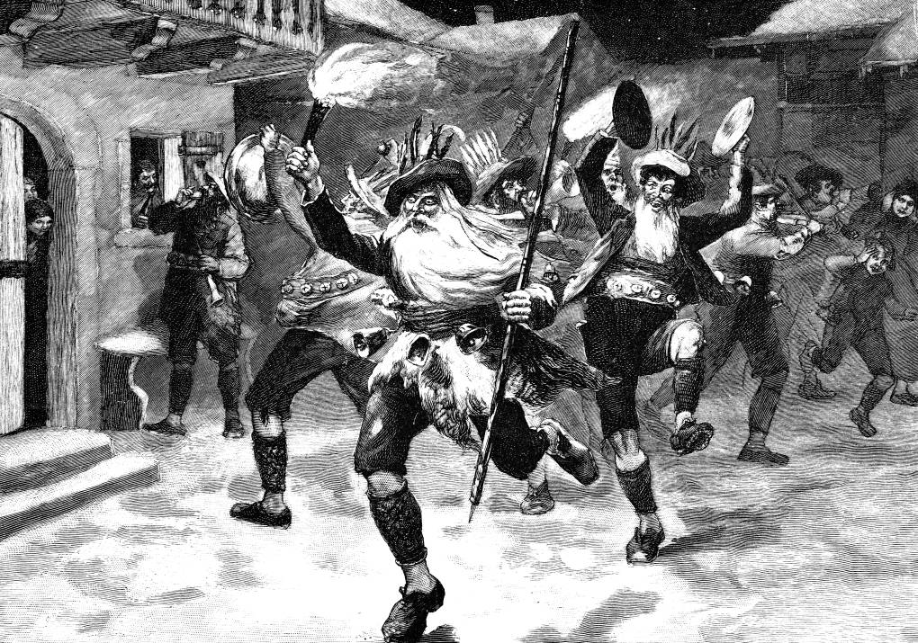 A 19th century illustration of a man with a long white beard and hat running through the street waving a torch. Men banging cymbals run behind him.