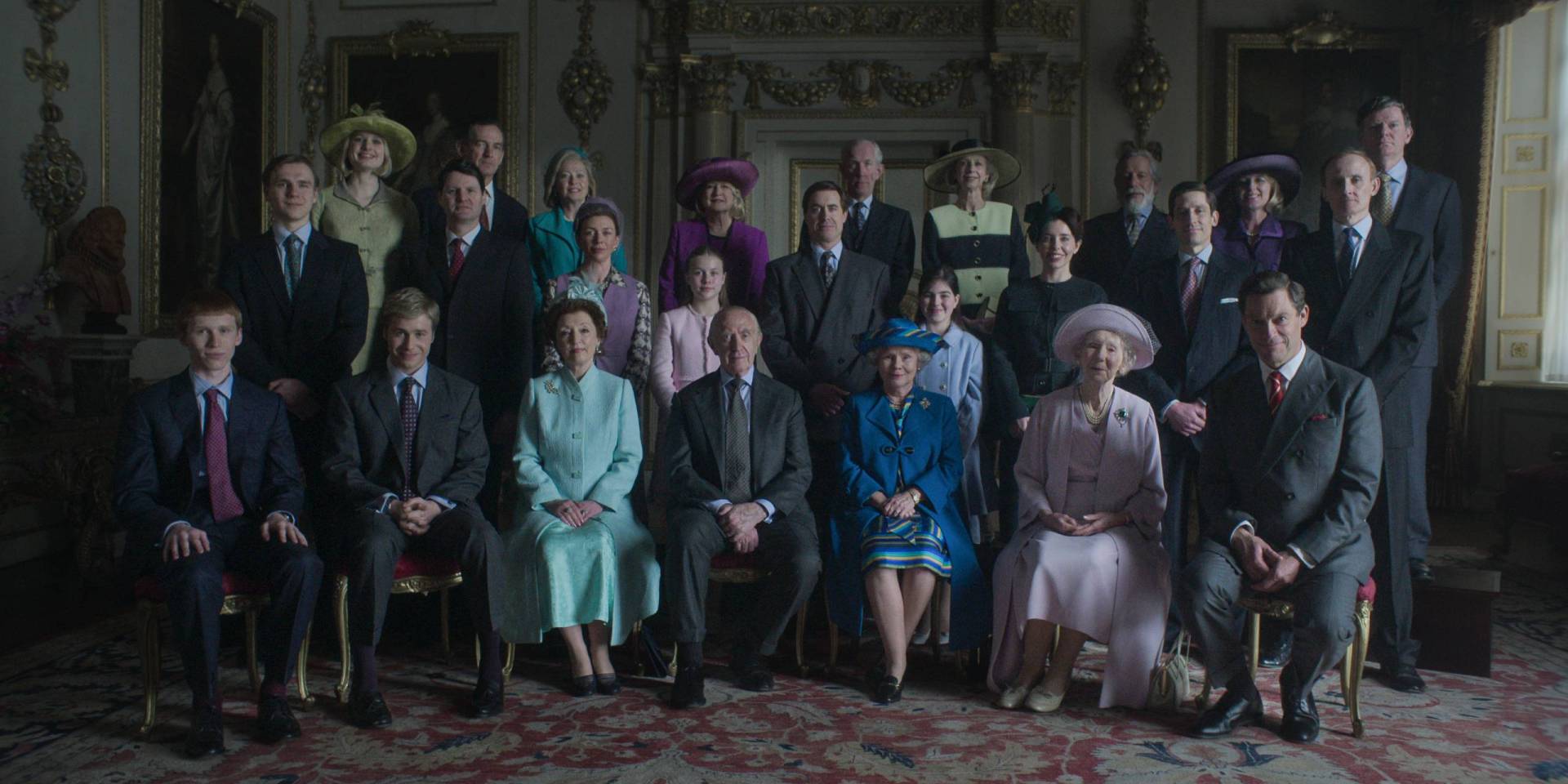 A formal portrait of 25 formally dressed people of varying ages, arranged into three rows.