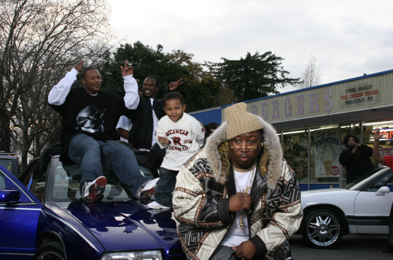 The ambassador of the Bay, E-40, sitting on his scraper watching Oakland going wild while on the set of the video for the hit song "Tell Me When To Go".