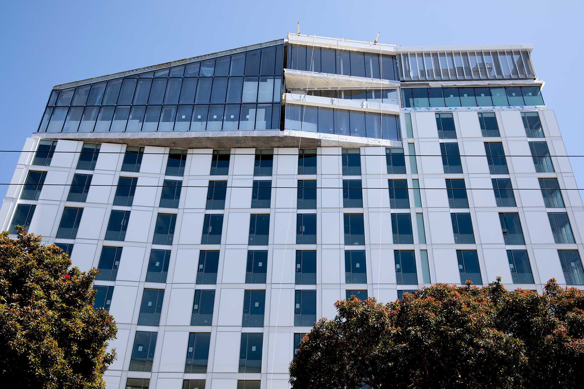 A building with a decorative top floor against a blue sky