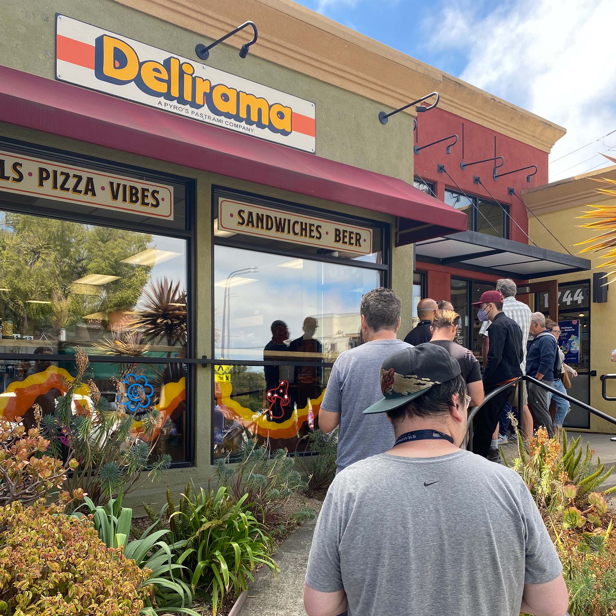 A long line of customers wait outside Delirama restaurant.