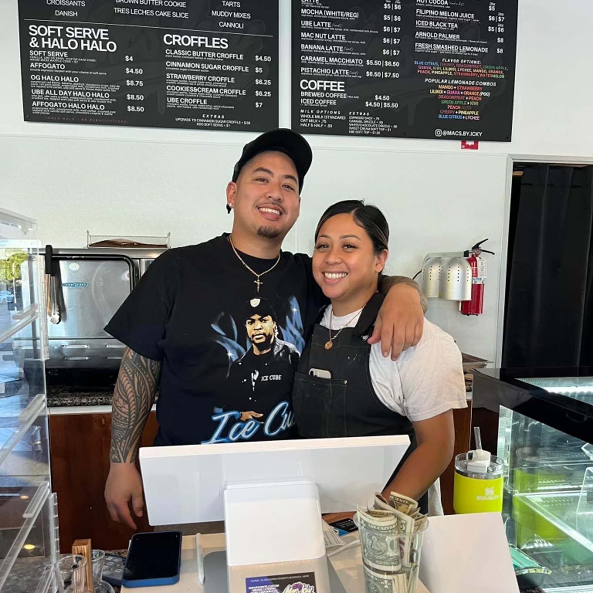a young Filipino couple stands in their newly opened cafe