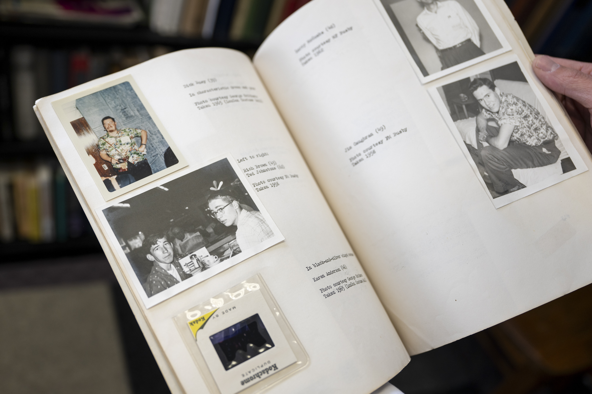 Open spread of photographs pasted into book with typed descriptions
