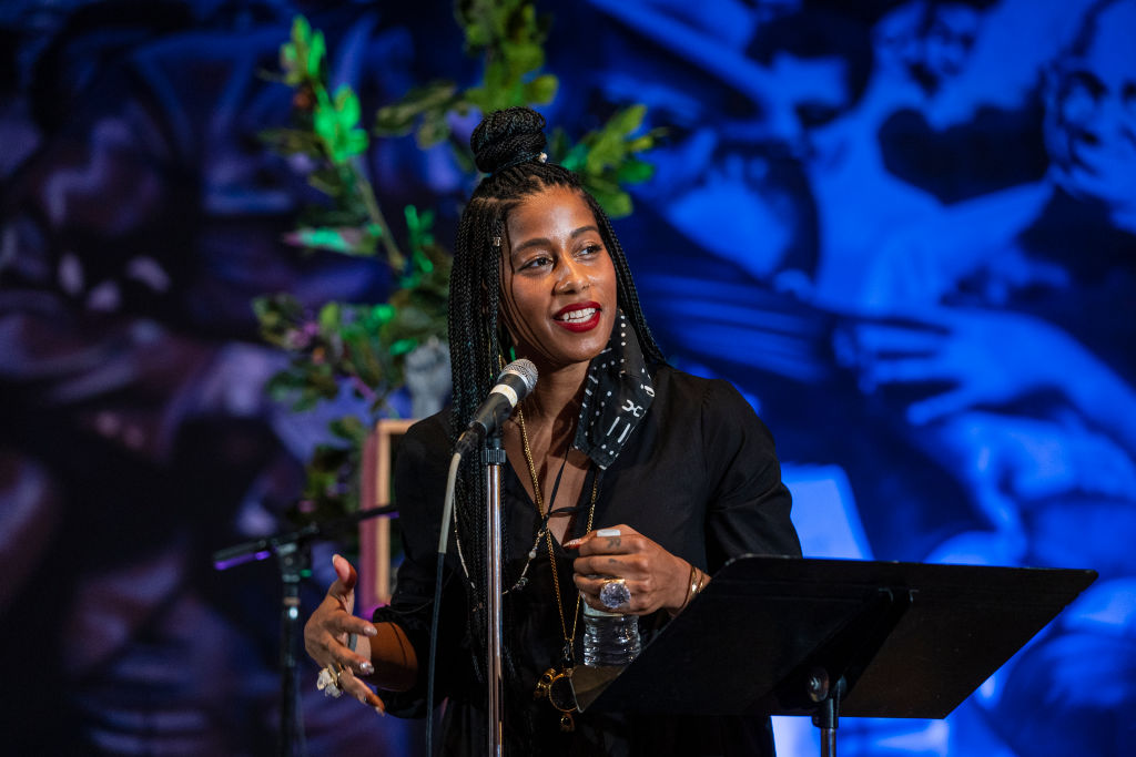 A poet smiles at a podium.