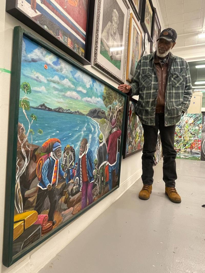 Painter Ira Watkins shows one of his many pieces that adorn the walls of his studio in Hunters Point Shipyard. 