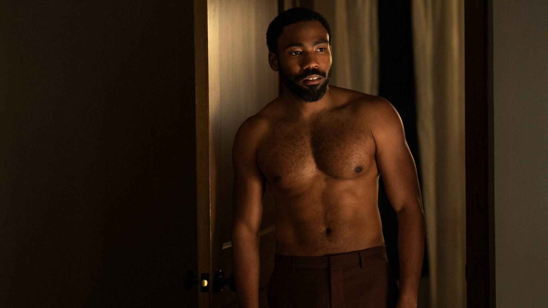 A muscular and shirtless Black man.