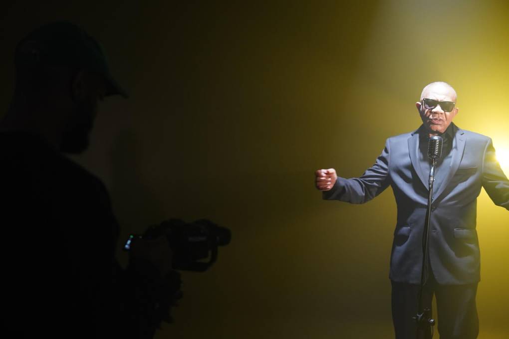Legendary soul singer Lenny Williams wears a dark suit and dark shades, as he performs during the making of the music video for his song "She Took My Drawers".