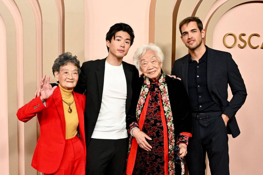 Two young men pose with two elderly Chinese women at an Academy Awards event