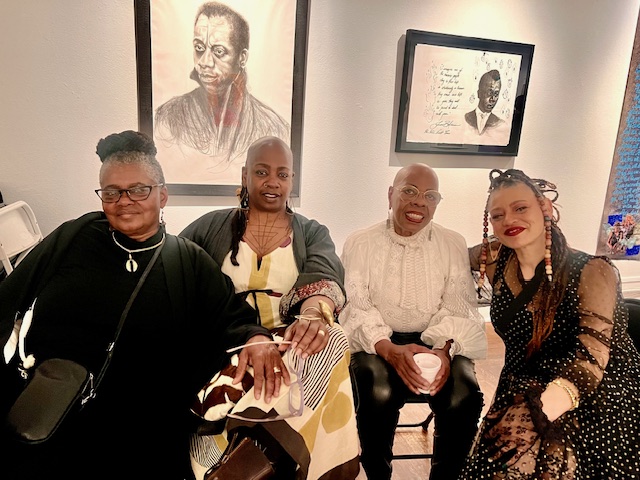 Four women sit and pose for a photo at the Joyce Gordon Gallery in Oakland.