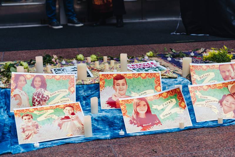 Posters with names and photographs of children killed in Gaza sit on the steps outside of Senator Padilla's office in San Francisco, CA